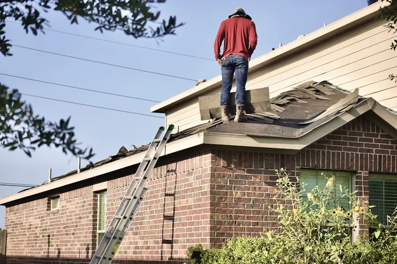 Professional roofer working on a residential roof in Pine Haven